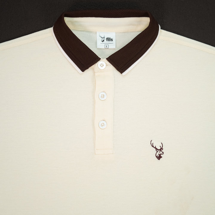 Beige polo shirt with brown collar and fils logo on a black background