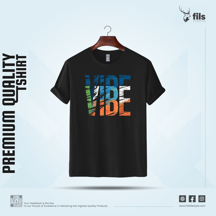 Black t-shirt with colorful text design on a hanger against a light blue background, featuring the brand 'fils'.