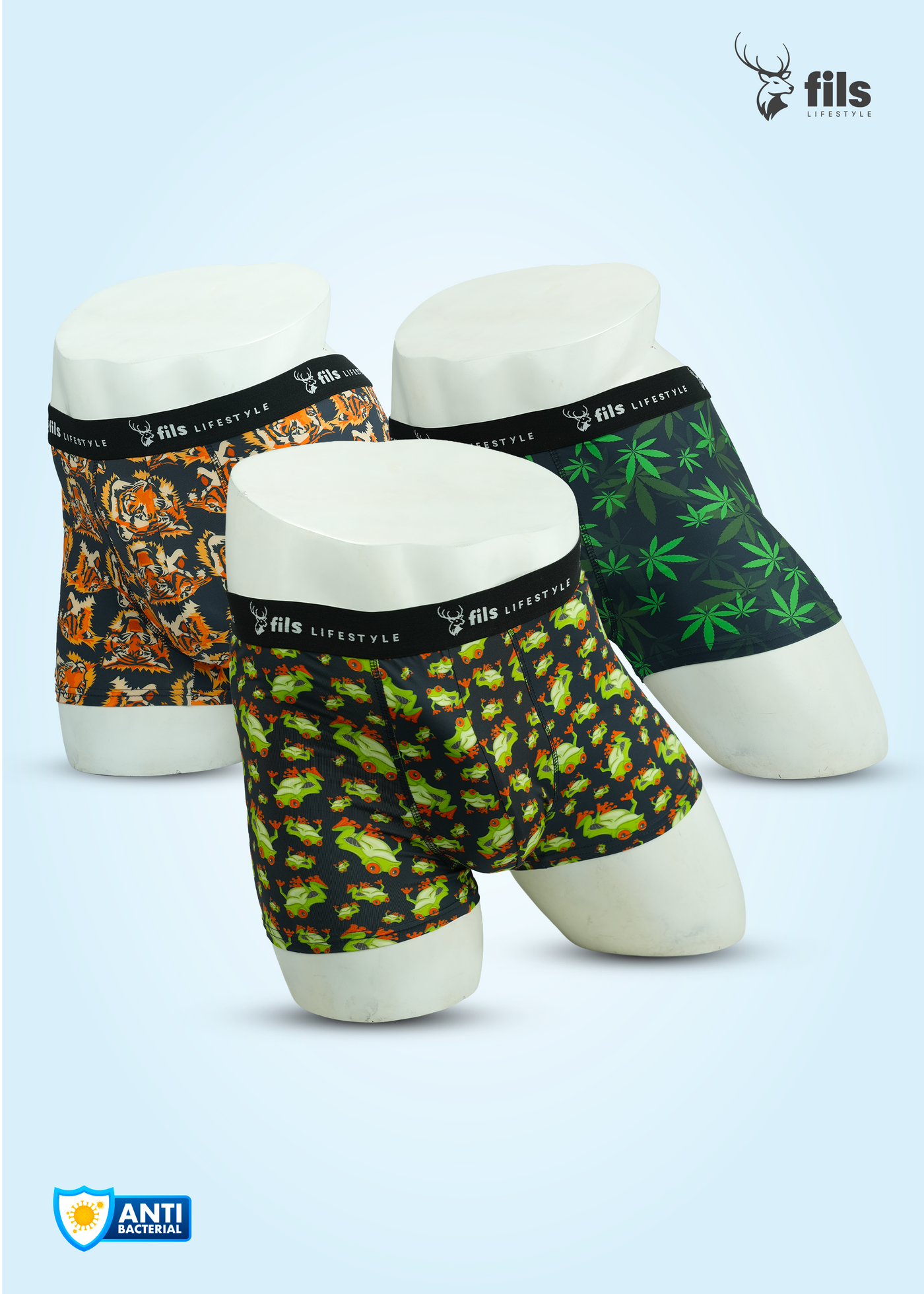 Three pairs of patterned boxer briefs on mannequin stands with 'fils' branding.