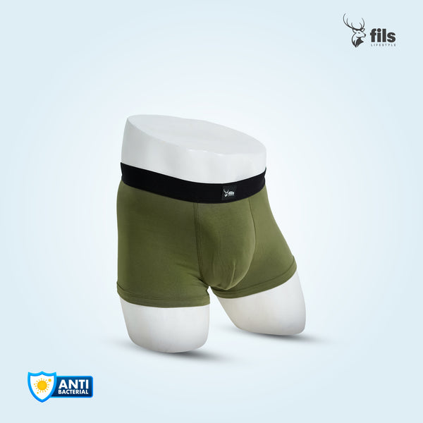 Green boxer briefs with a black waistband on a white mannequin against a light blue background, featuring the 'fils' brand.