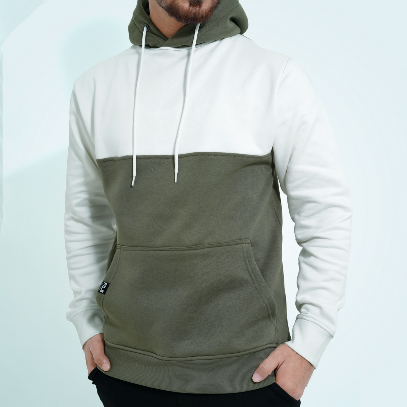 Male model wearing the Fils Premium Pullover Hoodie in Frosty Olive showing front side.