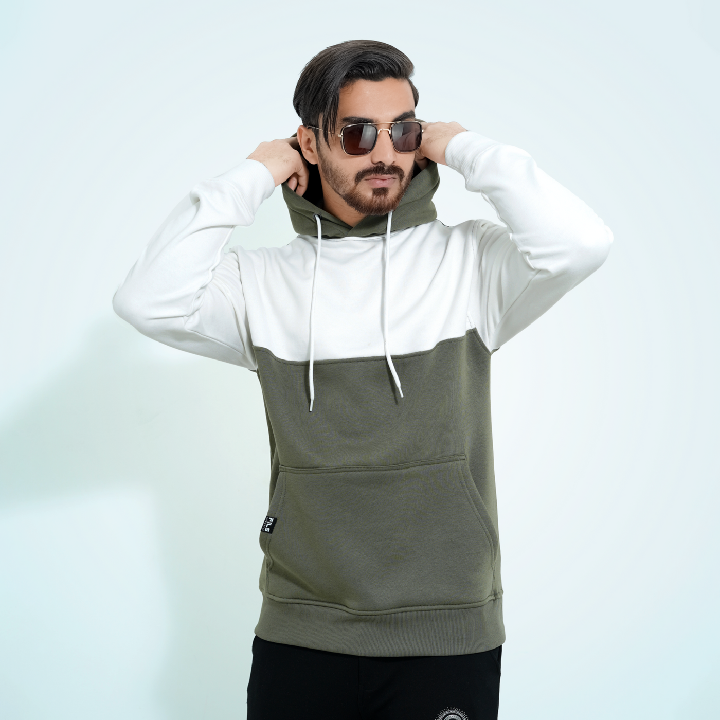 Male model wearing the Fils Premium Pullover Hoodie - Frosty Olive.