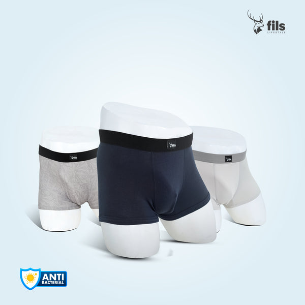 Three pairs of men's underwear in different colors on a dark background with 'fils' branding.