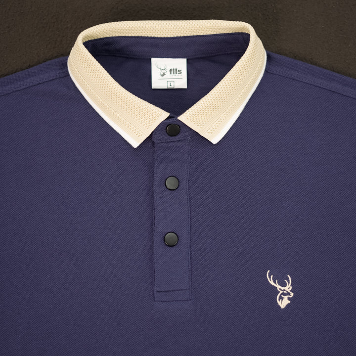 Navy blue polo shirt with beige collar and fils logo on a dark background