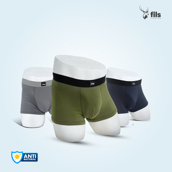 Three pairs of men's underwear in gray, green, and black on a dark background with 'fils' branding.