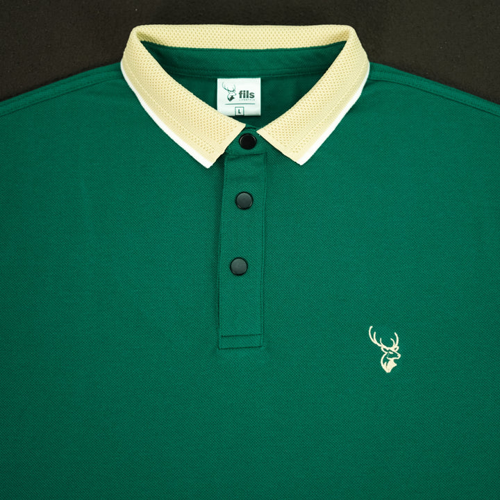 Green polo shirt with a white collar and fil logo on a black background