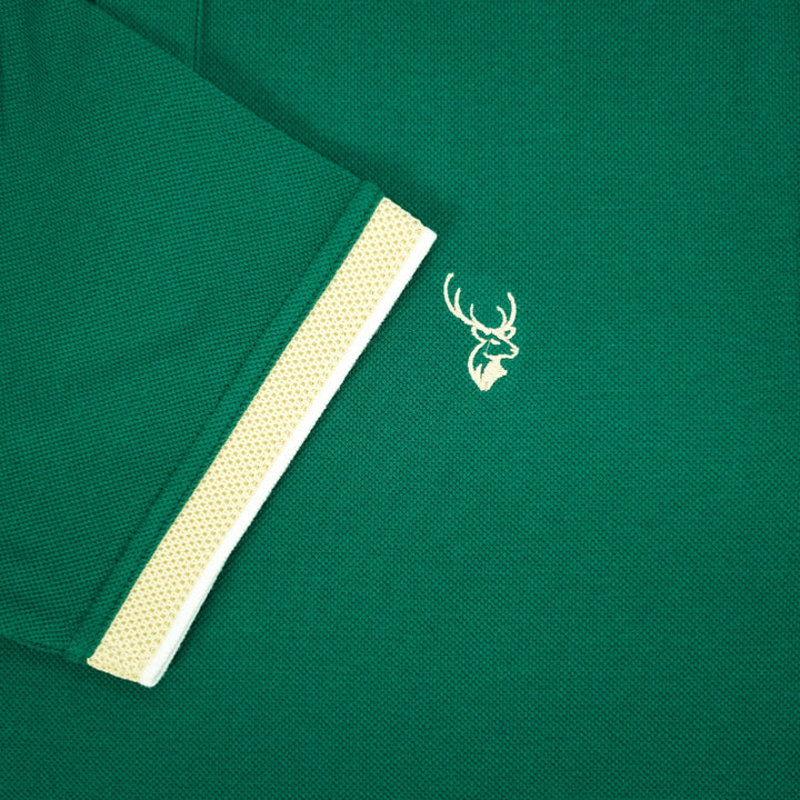Green polo shirt with a fils logo on a green background