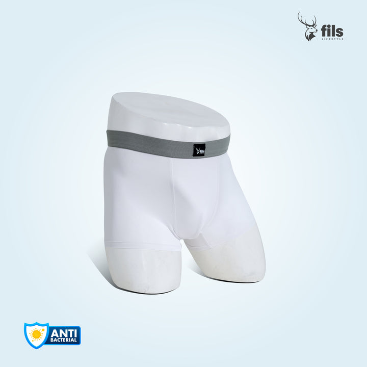 White underwear with a gray band on a dark, urban street background with 'fils' branding.